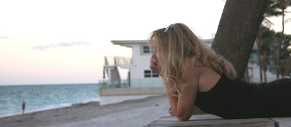 sad woman at beach facing ocean