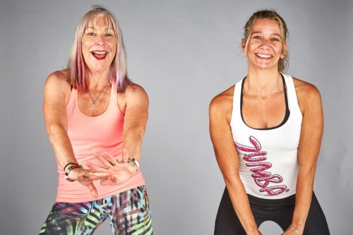 two women facing camera doing a dance routine