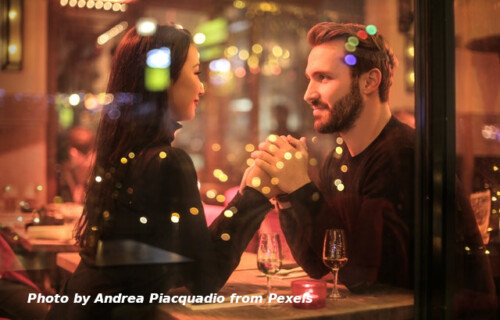 Couple in restaurant holding hands