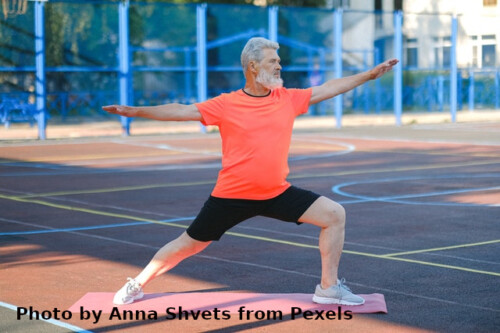 man doing a stretching excercise with outstreched arms forward and back