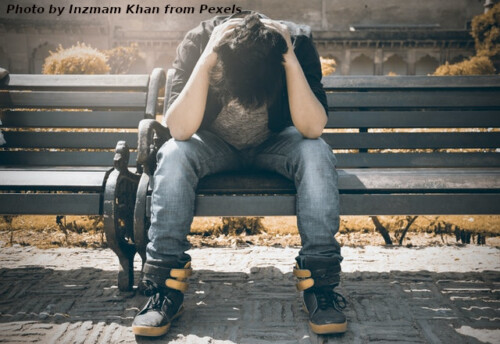 sad man on park bench