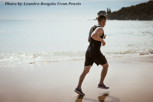 man jogging on beach