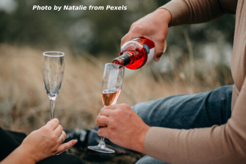 man filling wine glass