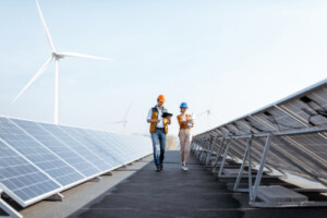 two people inspecting solar panels