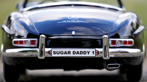 REAR VIEW OF CLASSIC MERCEDES 300 WITH SUGAR DADDY 1 ON LICENSE PLATE