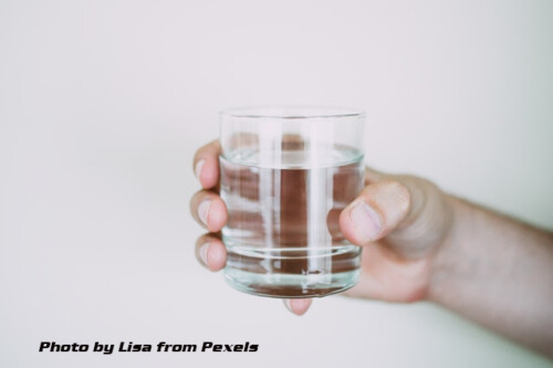 hand with glass of water
