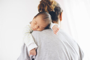 mother with baby on shoulder