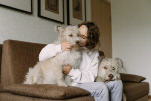 woman on couch with two dogs