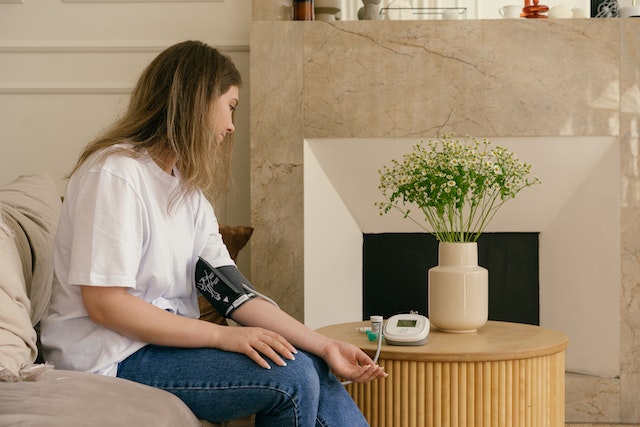 woman testing her blood pressure