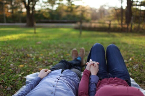 couple laying on grass